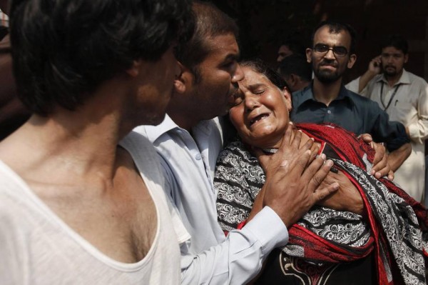 A Christian woman mourns the death of her son at the site of a suicide blast at a church in Peshawar